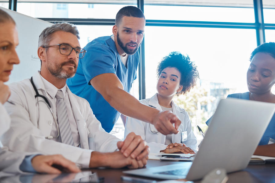 Providers huddled around conference table