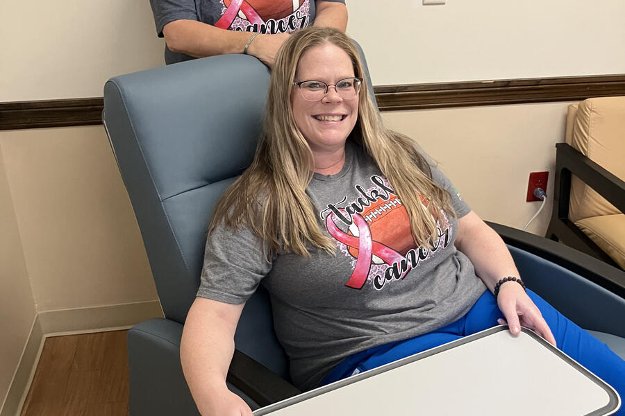 Patient Seated in new infusion chair; other person standing behind