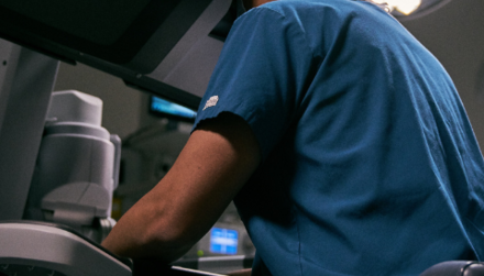 Surgeon seated, using davinci 5 surgical system