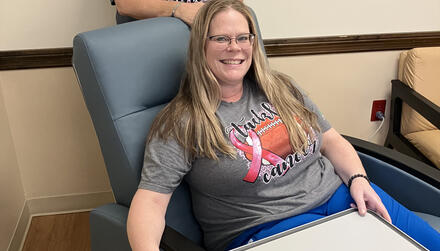 Patient Seated in new infusion chair; other person standing behind