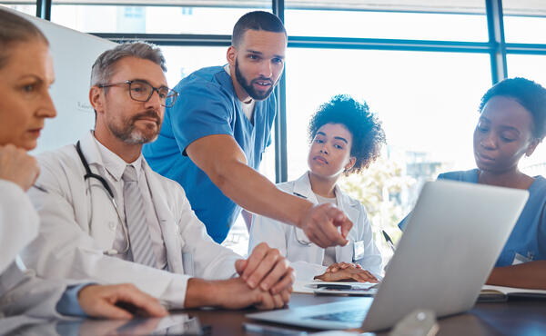 Providers huddled around conference table
